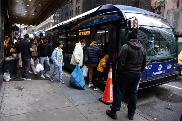 Migrants leaving the Roosevelt Hotel in Manhattan on Dec. 27, 2023.