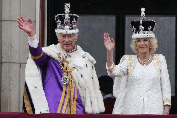 Britain's King Charles III and Queen Camilla wave to the crowds from the balcony of Buckingham Palace.
