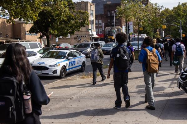A student is wheeled out of a Hells Kitchen school building on a gurney in May after another teen stabbed him