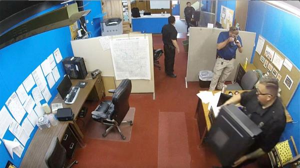 Police are seen raiding the Record.