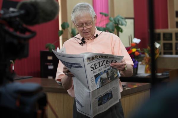 Paper owner Eric Meyer is pictured holding a copy of the newspaper.