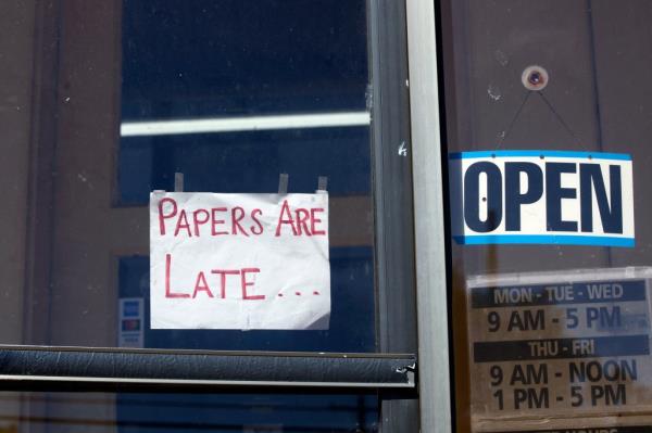 A sign on the paper's door saying papers would be late.