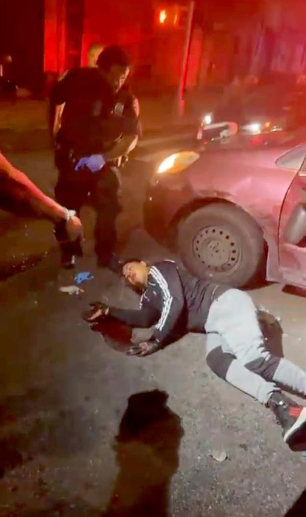 Ano<em></em>nymous cell video of scooter gunman struck by a car on ground.
