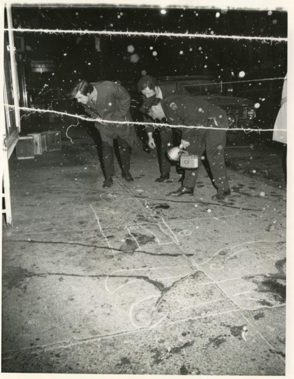 Crime scene photo of chalk outlines.