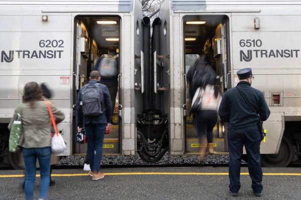 A co<em></em>nductor waits for passengers to board an NJ Transit train at the Clifton Station on Thursday April 11, 2024.