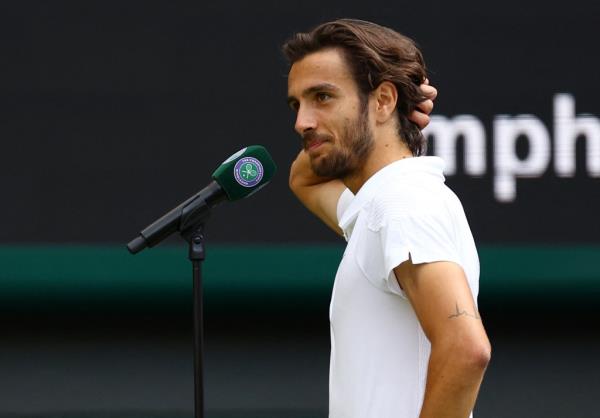 Italian tennis player Lorenzo Musetti speaking to the crowd after winning his quarter final Wimbledon match in London, 2024