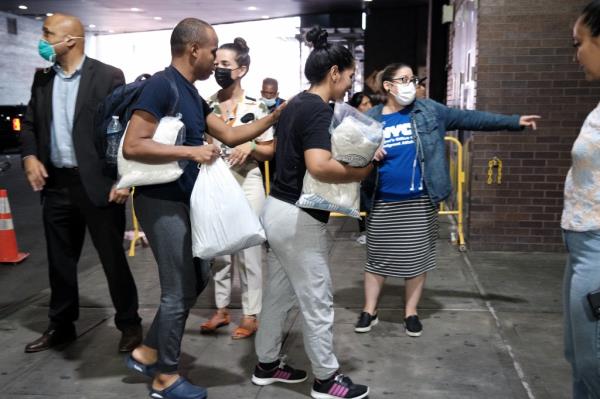 Migrants who crossed the border from Mexico into Texas exit a bus as it arrives into the Port Authority bus station in Manhattan on August 25, 2022