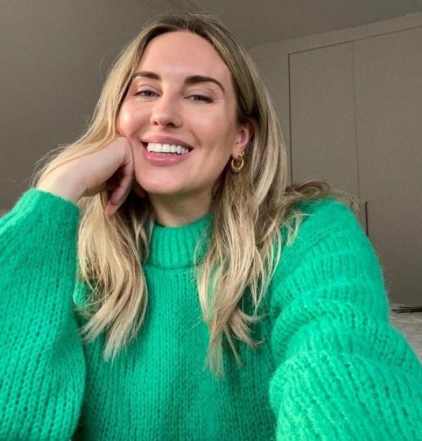 Emily Valentine wearing a green jumper