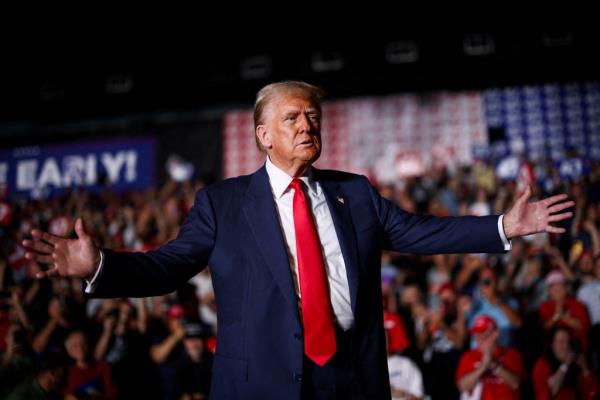 Former U.S. President Do<em></em>nald Trump reacting during a rally in Greensboro, North Carolina in 2024 with his arms outstretched