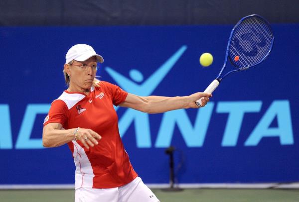 Martina Navratilova playing tennis. 