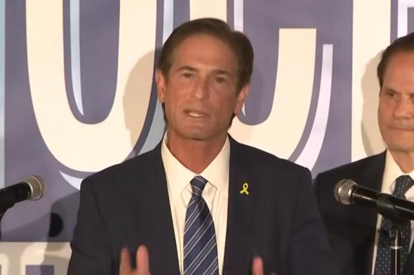 Nathan Hochman speaks at a podium