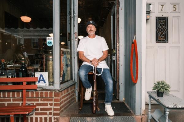 Mark Iacono, founder and owner of Lucali, holding a ba<em></em>seball bat given to him by New York Yankee Anthony Volpe in New York, NY on October 30, 2024