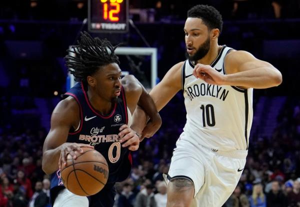 Ben Simmons, who had five assists and nine rebounds, defends Tyrese Maxey during the Nets' loss.