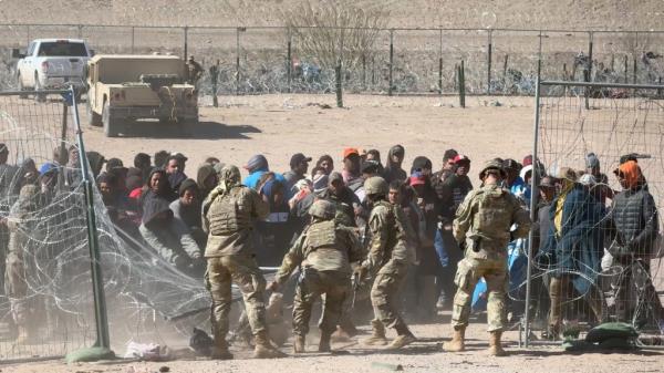 Soldiers at the border in El Paso, Texas, attempt to co<em></em>ntrol dozens of migrant rioters who tried to make their way in during a wild caught-on-camera scene captured by The Post in March.