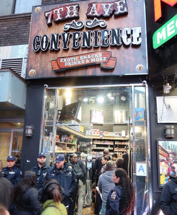 NYPD officers outside of a illegal pot shop in Times Square during a raid.