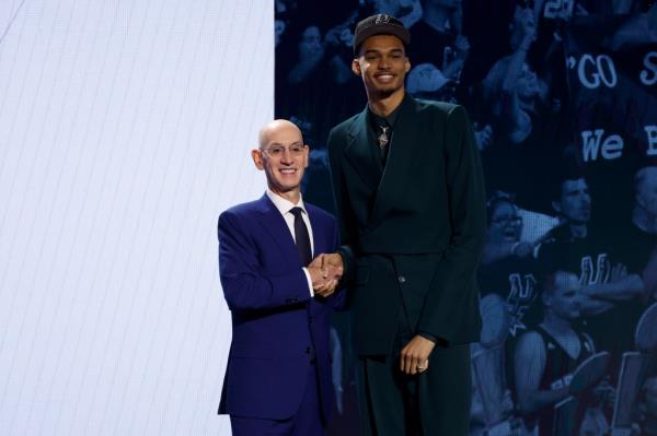 Victor Wembanyama (R) poses with NBA commissio<em></em>ner Adam Silver (L) after being drafted first overall pick by the San Anto<em></em>nio Spurs during the first round of the 2023 NBA Draft