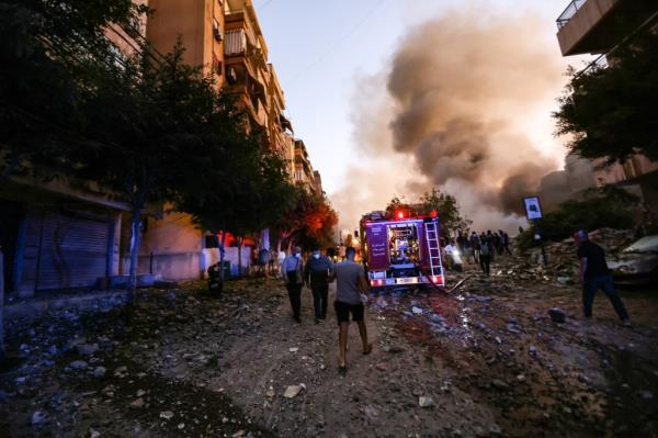 First respo<em></em>nders rush to the site of an Israeli airstrike in the Haret Hreik neighborhood in Beirut on Sept. 27, 2024.