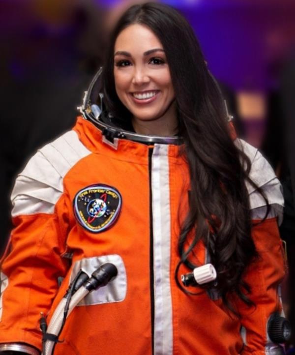 Kellie Gerardi, Scientist-Astro<em></em>naut in her spacesuit.