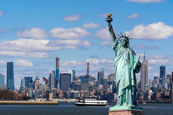 The Statue of Liberty over the Scene of New york cityscape river side.