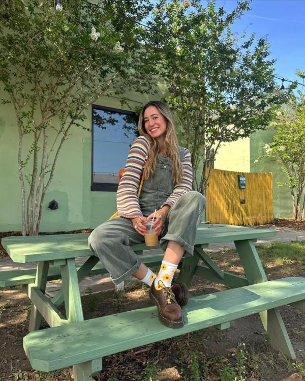 Woman sitting on green table.