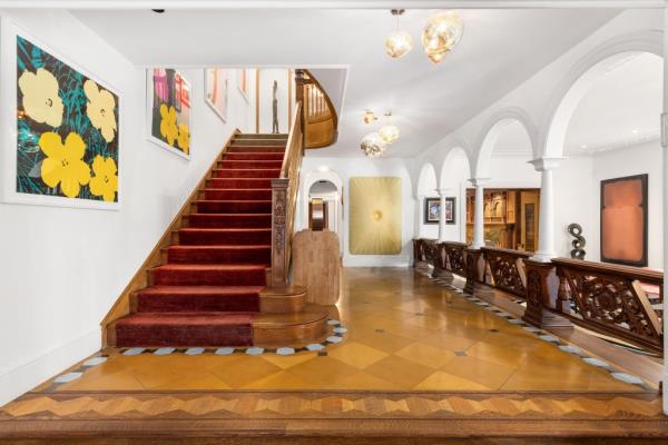 A staircase co<em></em>nnects the levels, with wall space fit for displaying art.