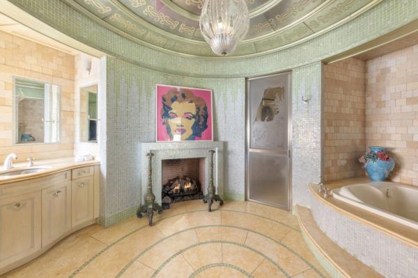 A fireplace warms this bathroom.