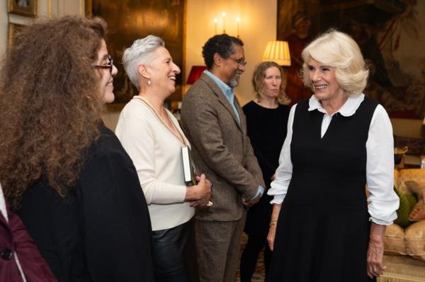 Queen Camilla (R) talks with Charlotte Wood during a reception for The Booker Prize Foundation at Clarence House on November 12, 2024 in London, England.