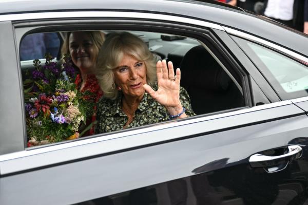 Queen Camilla waves from the car as she leaves the Dyson Cancer Centre at the Royal United Hospitals Bath NHS Foundation Trust in Bath, western England, on September 3, 2024.