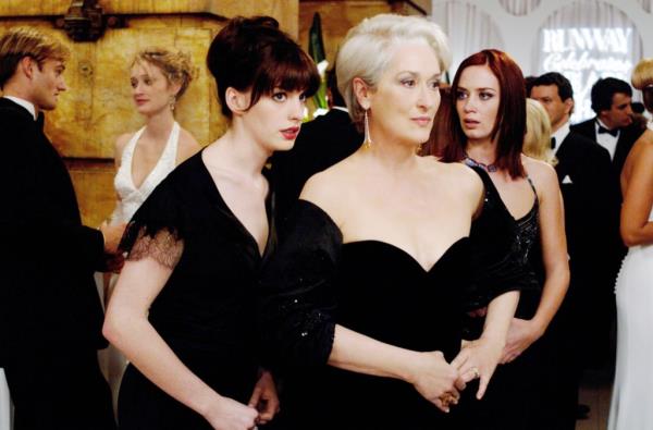 Anne Hathaway, Meryl Streep, and Emily Blunt standing together. 