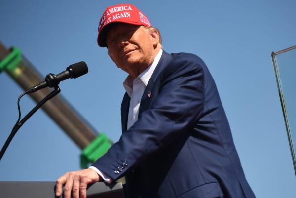 Do<em></em>nald Trump in a suit and red hat speaking to thousands of supporters at the Aero Center, Wilmington Internatio<em></em>nal Airport, September 21, 2024