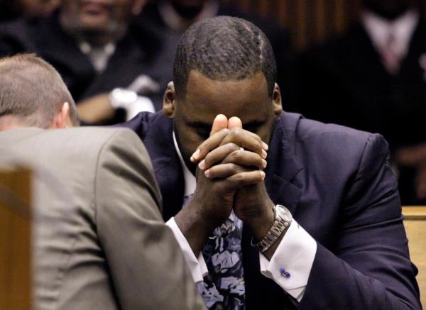 Former Detroit Mayor Kwame Kilpatrick in a suit with his hands together in Wayne County Circuit Court for his sentencing in October 2008.