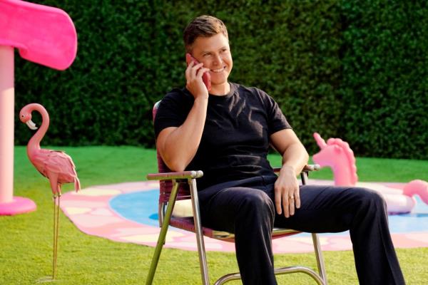 Colin Jost on a pink phone on