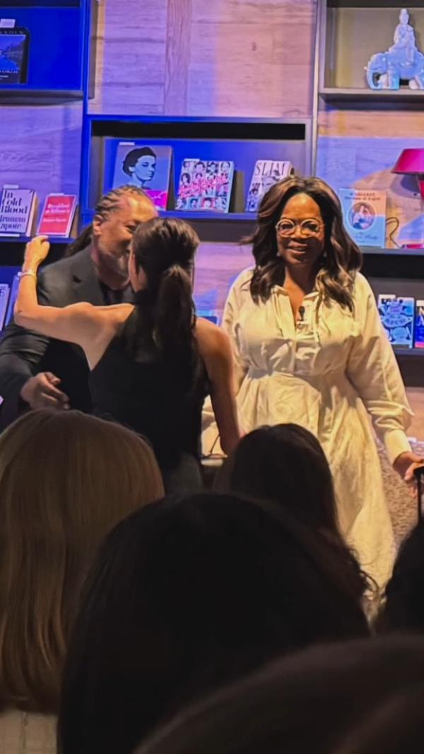 Meghan Markle and Oprah Winfrey attending the grand opening of Godmothers bookstore in Summerland, California, surrounded by a crowd
