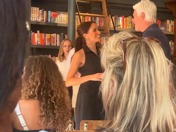 Meghan Markle, Duchess of Sussex, in a navy blue tuxedo jumpsuit from Club Monaco, making a surprise appearance at a bookstore opening event in Santa Barbara, California