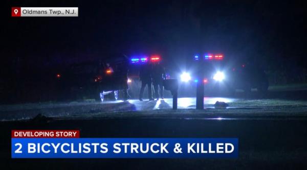 Police officers standing at the night-time scene of a fatal accident wher<em></em>e two bicyclists, including NHL star Johnny Gaudreau, were struck and killed by a vehicle.