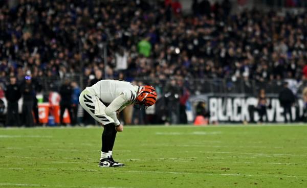 Cincinnati Bengals quarterback Joe Burrow reacts to an injury after a play during the second quarter against the Baltimore Ravens at T Bank Stadium on Thursday night Nov 16. 