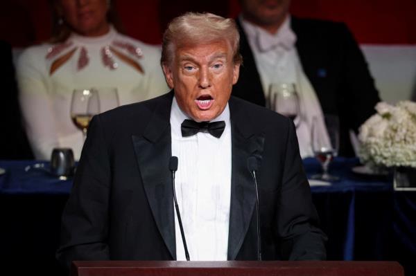 Former U.S. President Do<em></em>nald Trump, in a tuxedo, speaking into a microphone at the 79th annual Alfred E. Smith Memorial Foundation Dinner in New York City, October 17, 2024.
