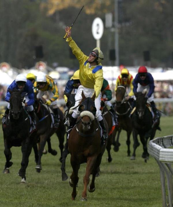 Damien Oliver celebrates on Media Puzzle after the 2002 Melbourne Cup. 