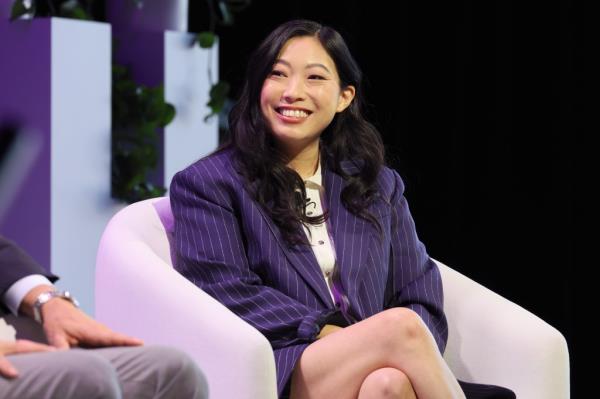 Awkwafina smiles as she speaks on stage. 
