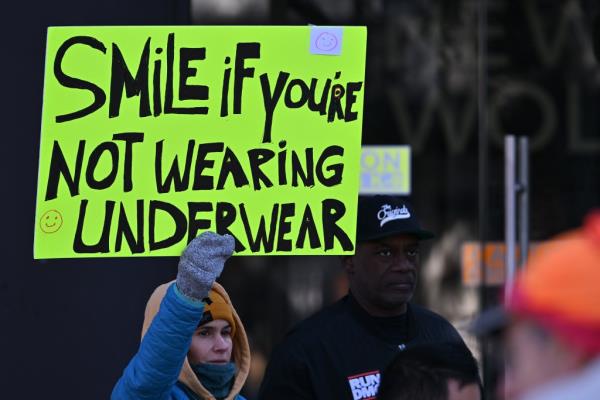 A woman holding a sign.