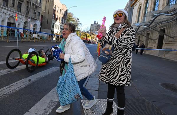 Berta Romero-Gallon and Gloria Romero-Gallon came out to support Berta's son, Andres Giraldo, as he ran near Layafette Avenue and Ashland Place, Brooklyn.
