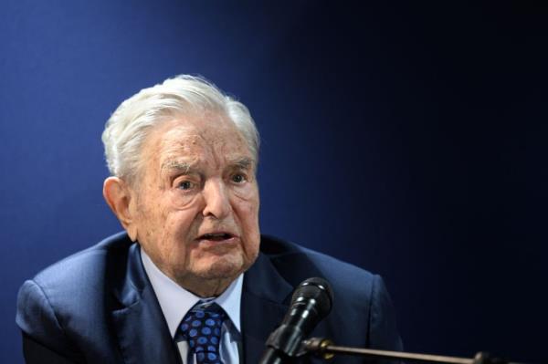 George Soros, wearing a suit and tie, answering questions after delivering a speech at the World Eco<em></em>nomic Forum annual meeting in Davos