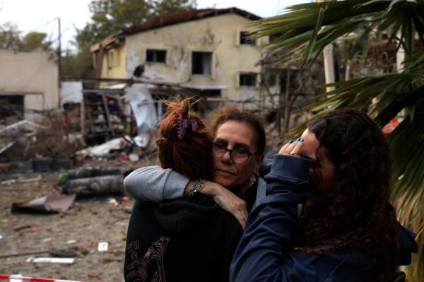 Residents embrace at the site of a rocket attack on Nov. 24, 2024 in Rinatya, Israel.