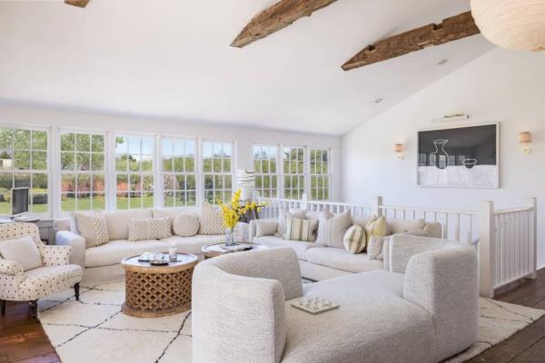 Design details like wooden beams and lots of sitting areas add to the home's charm, interior. 
