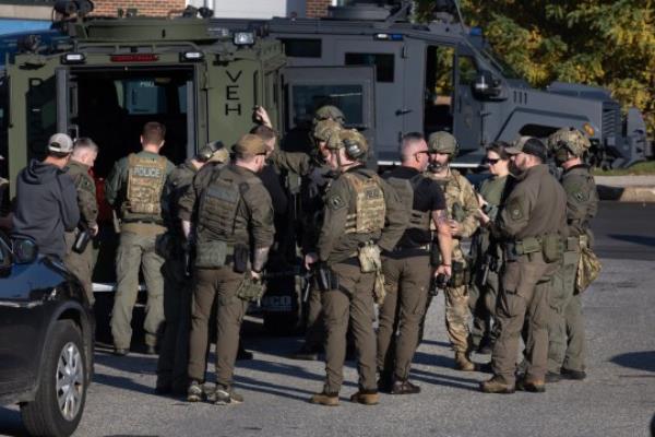 LEWISTON, MAINE - OCTOBER 27: Law enforcement officials gather at the Lewiston High School as they co<em></em>ntinue a manhunt for suspect Robert Card following a mass shooting on October 27, 2023 in Lewiston, Maine. Police are actively searching for a suspect, Army reservist Robert Card, who allegedly killed 18 people in a mass shooting at a bowling alley and restaurant in Lewiston, Maine. (Photo by Joe Raedle/Getty Images)