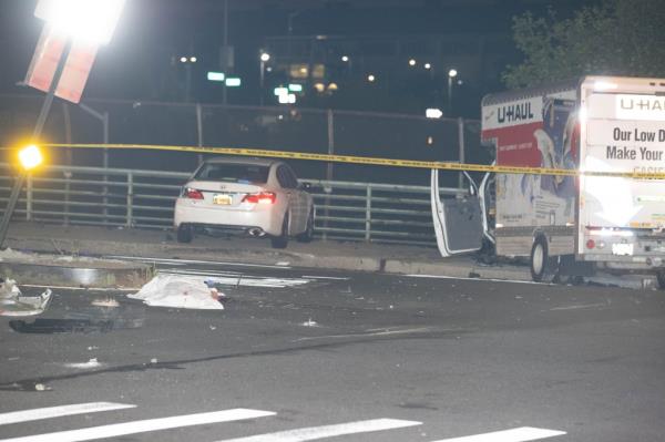 The body of a pedestrian is covered by a white sheet at the scene of a collision at Horrace Harding Parkway and Kissena Blvd. in Queens, Tuesday, August 20, 2024