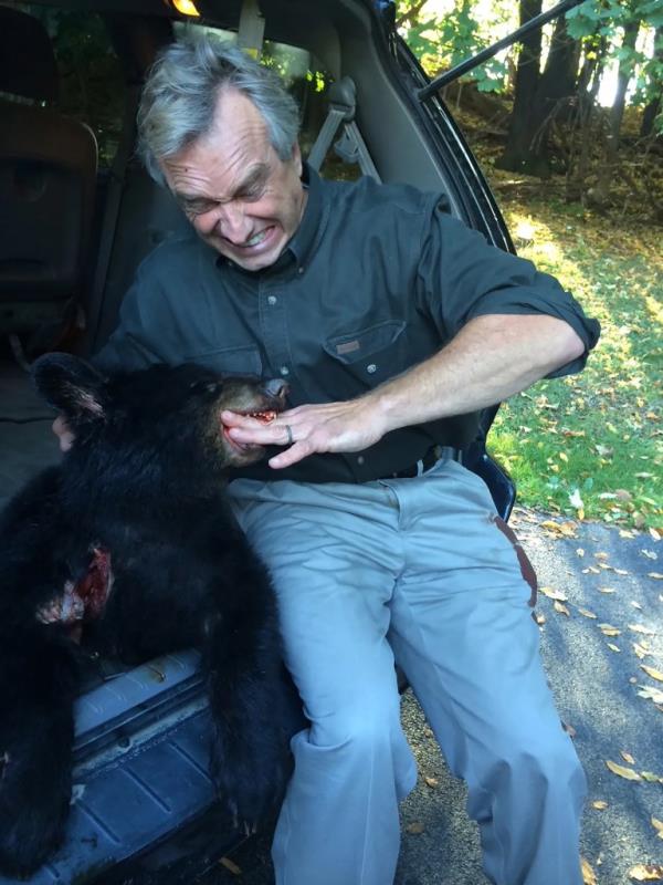 RFK Jr. with is hand in a dead bear's mouth