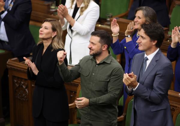 Ukrainian President Volodomyr Zelensky and Canadian Prime Minister Justin Trudeau are pictured cheering on Hunka.