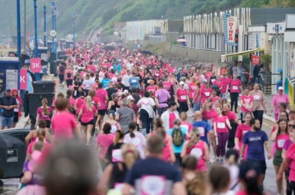 Fundraisers take part in a rainy Race For Life 5k run, organised by Cancer Research UK, along the seafront at Boscombe beach in Dorset. The Met Office has issued guidance that most of the UK will meet heatwave criteria next week, and an amber a<em></em>lert for hot weather for hot weather has been issued by the UK Health Security Agency (UKHSA). Picture date: Sunday June 11, 2023. PA Photo. Photo credit should read: Andrew Matthews/PA Wire