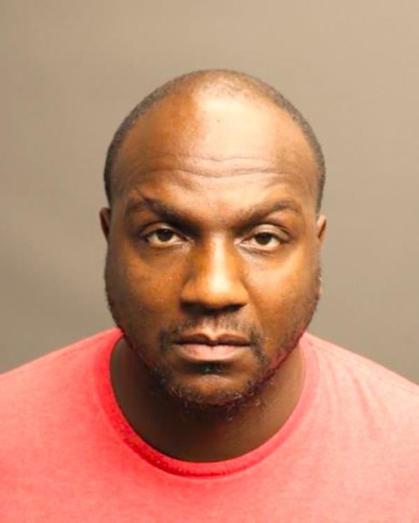 Mugshot of Freddie Lee Trone, named as the suspect in the fatal shooting of rapper PnB Rock, wearing a red shirt